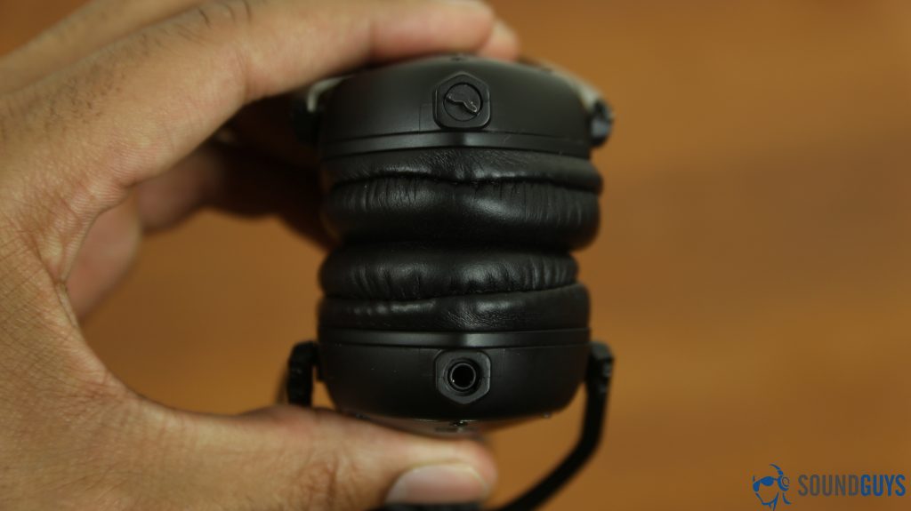 Best headphones under $200: V-Moda XS (balck) headphones in the hand, vewing the headphone jack.