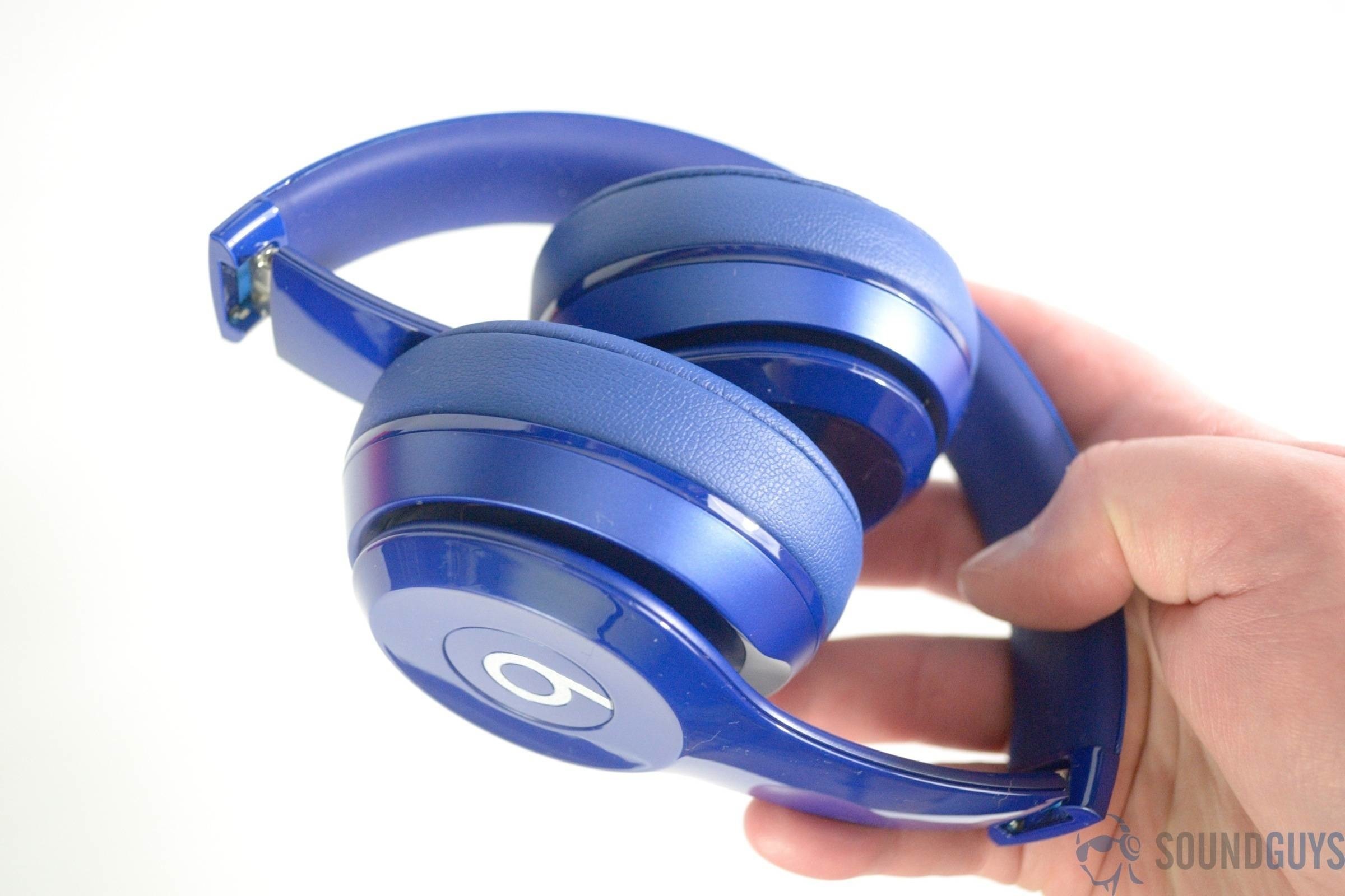 Pictured are the blue Beats Solo 2 in hand folded at the hinges. 