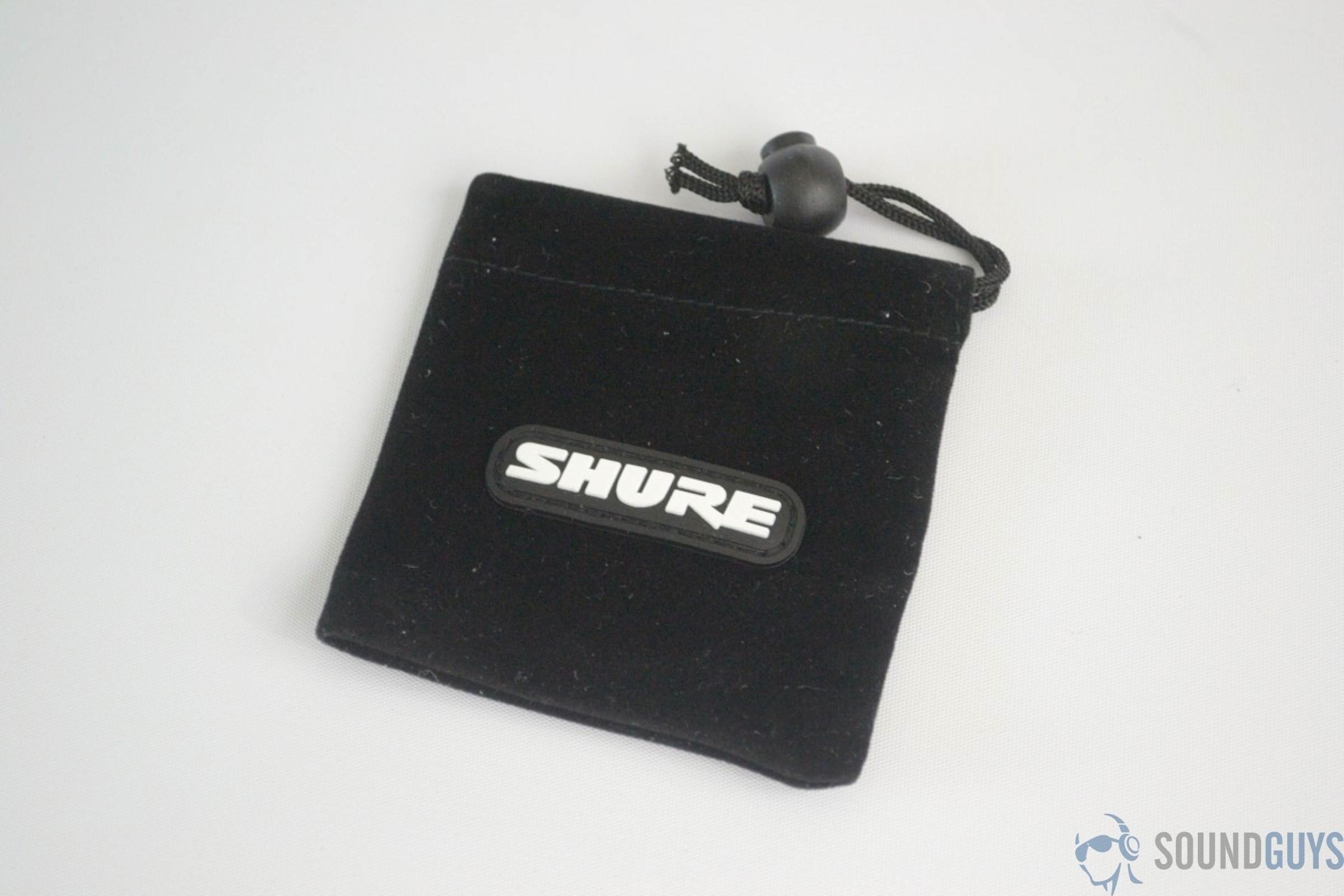 The square Shure SE112-GR earbud pouch in black on a white background.