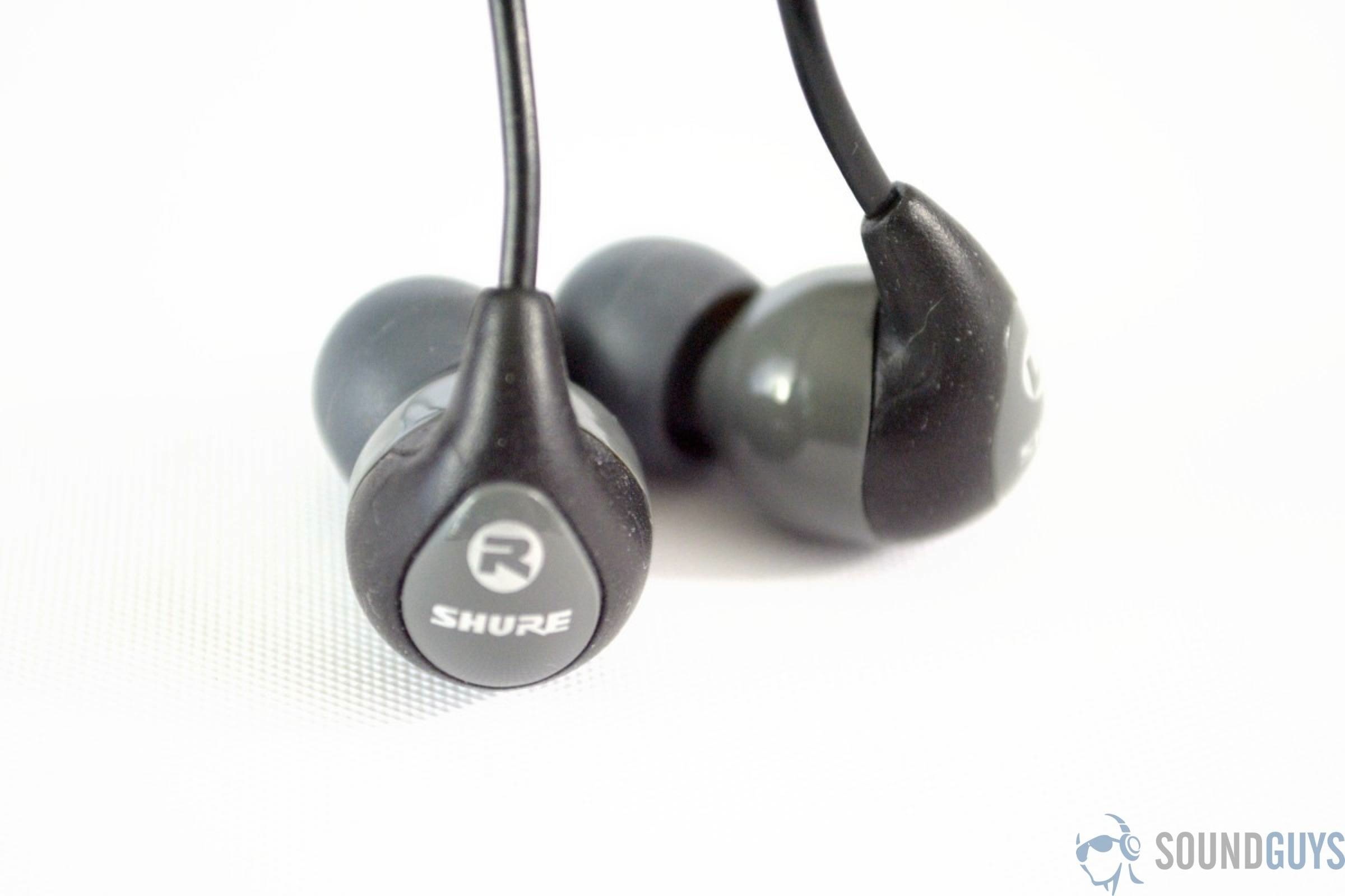 The Shure SE112 GR earbuds in grey on a white background.