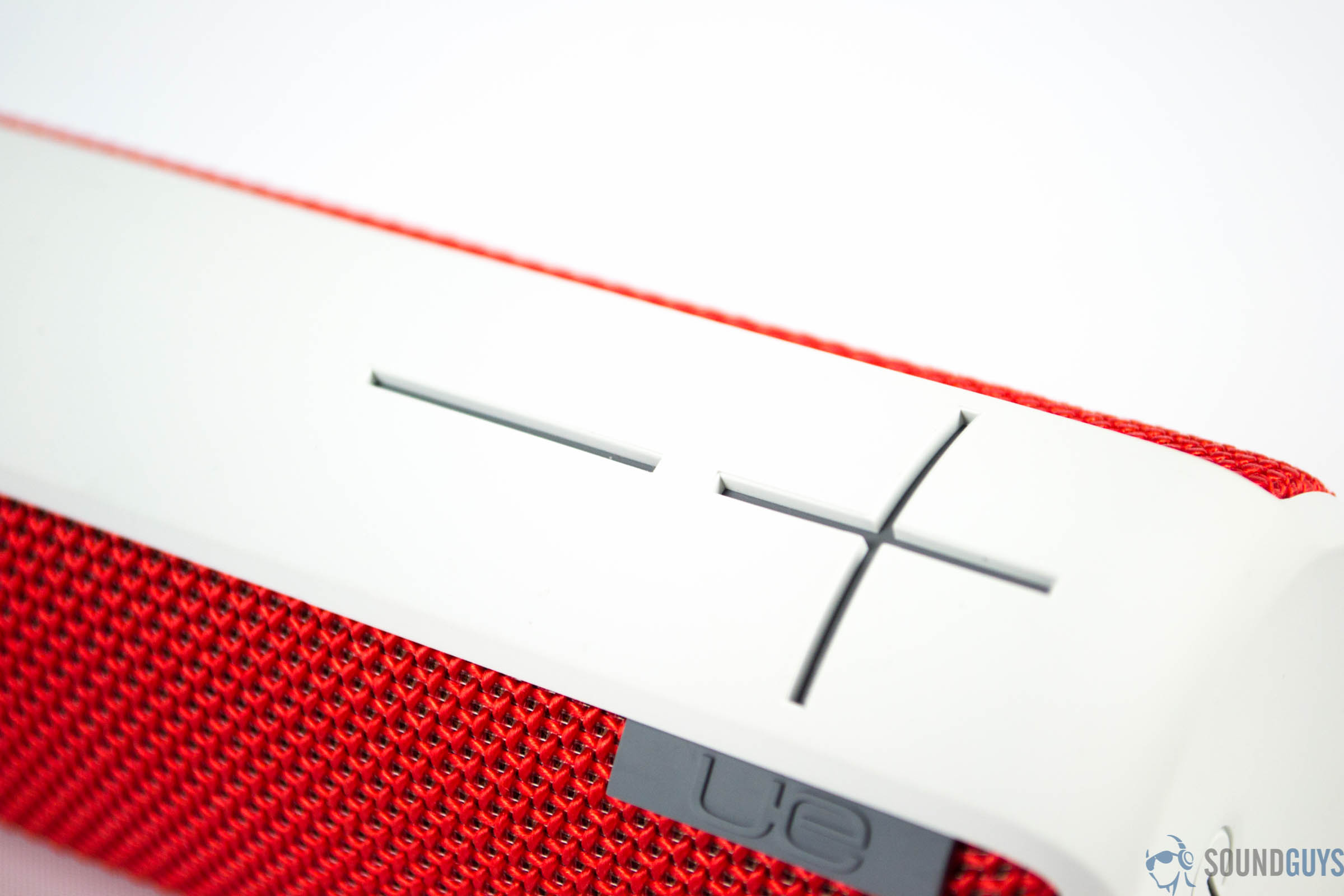 logitech-ue-boom-sg-4 Shot of the plus and minus signs on the front of the speaker against a white background.