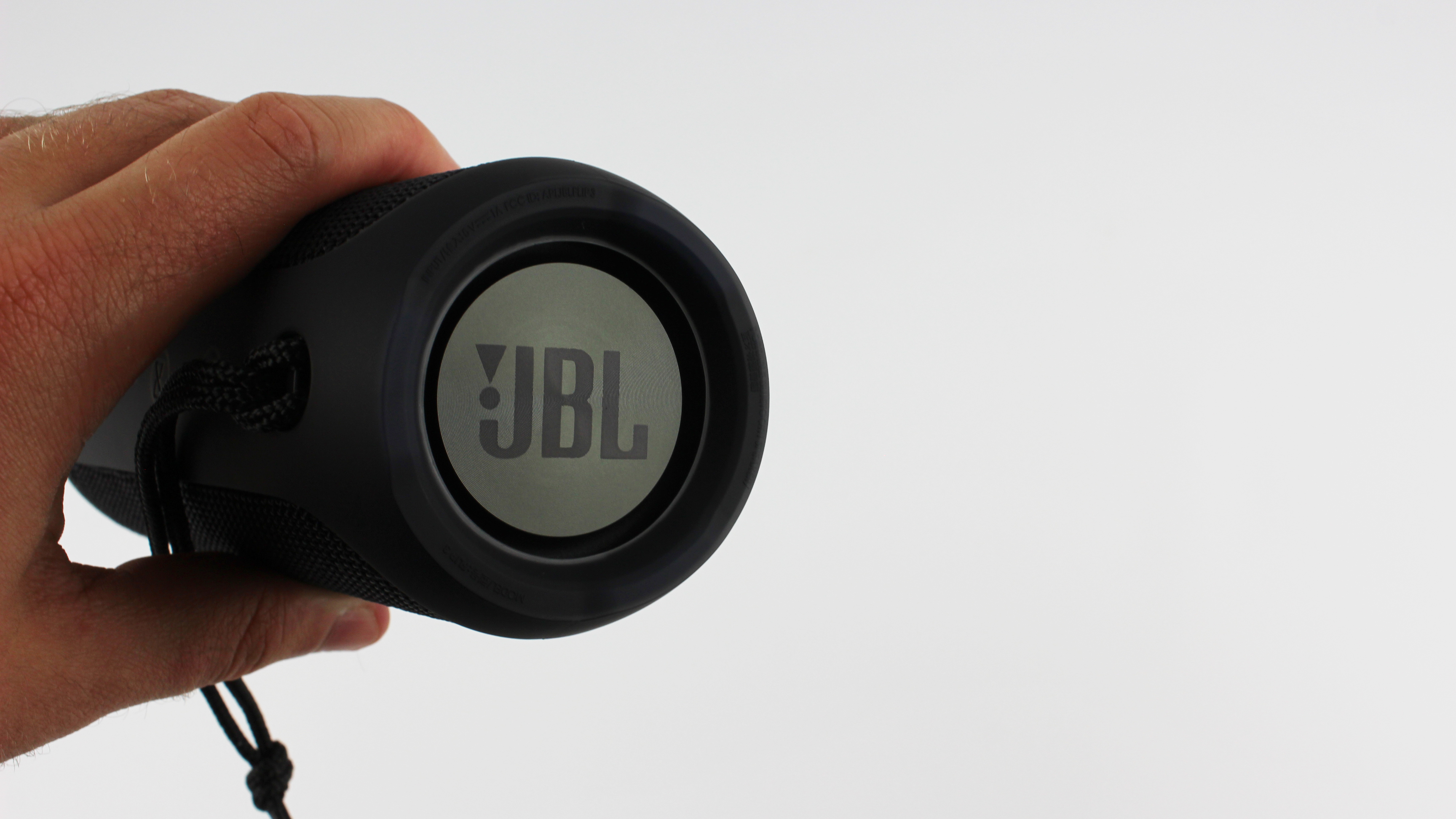 Pictured is Adam holding the JBL Flip 3 from the side.