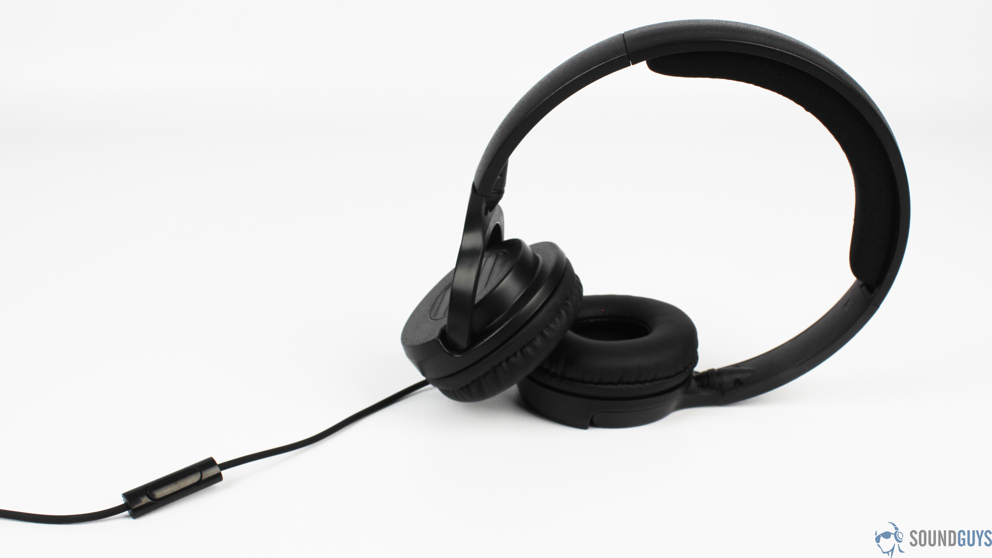 The Monoprice Hi-Fi On-Ear headphones in full view, stand on an ear cup with the wire in frame.