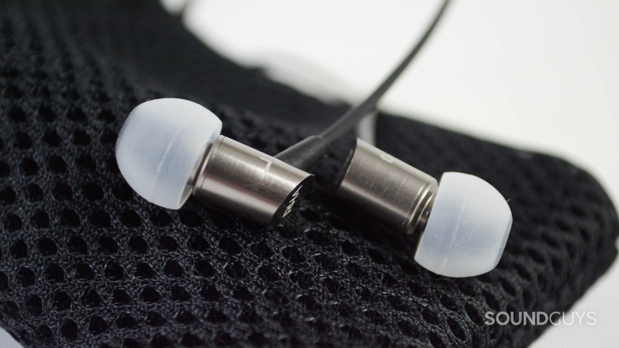 rha-s500i-sg-5 The RHA S500i earbuds on top of a mesh carrying pouch.