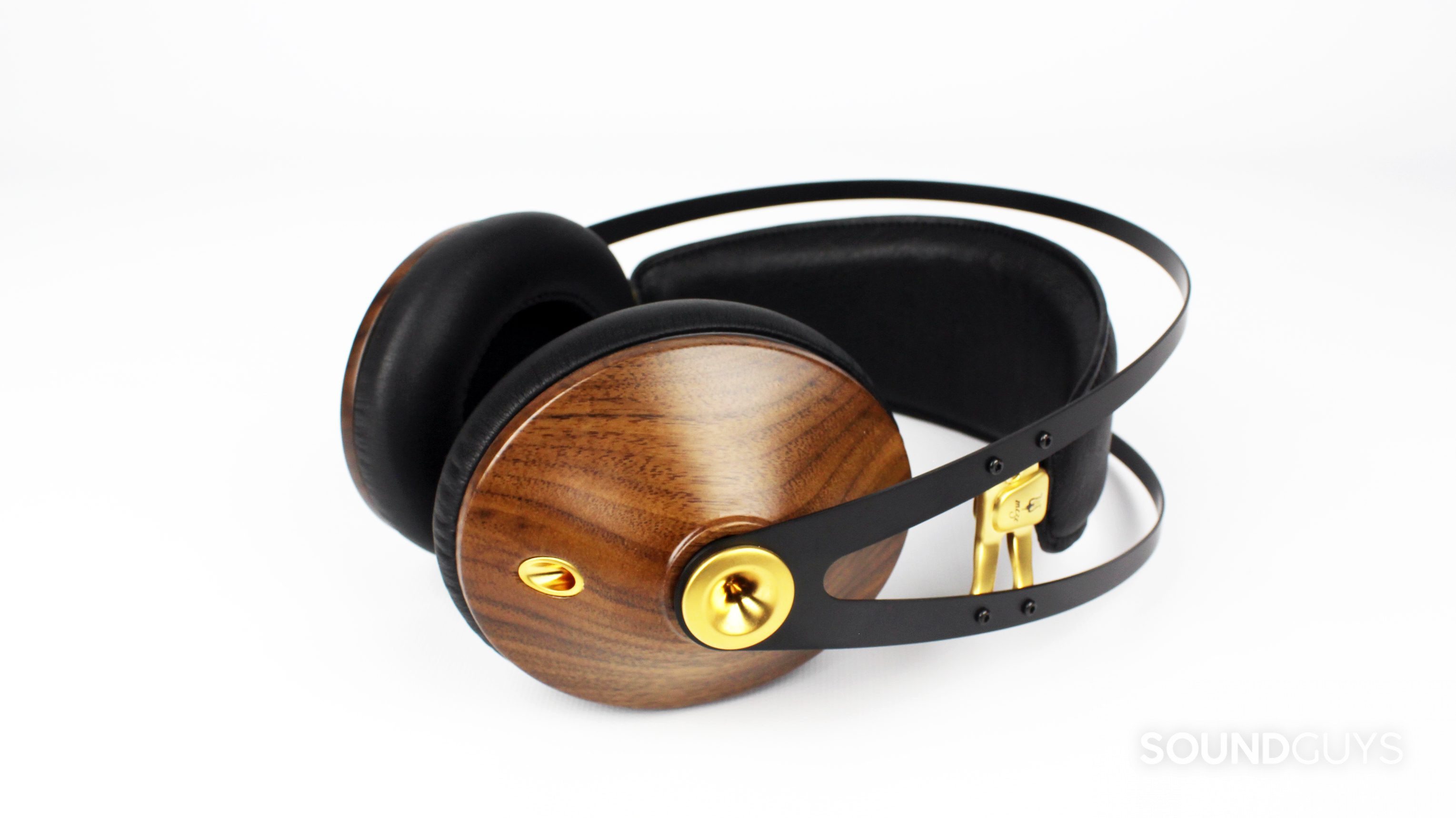 The Meze 99 Classics headphones in walnut/gold against a white backdrop.