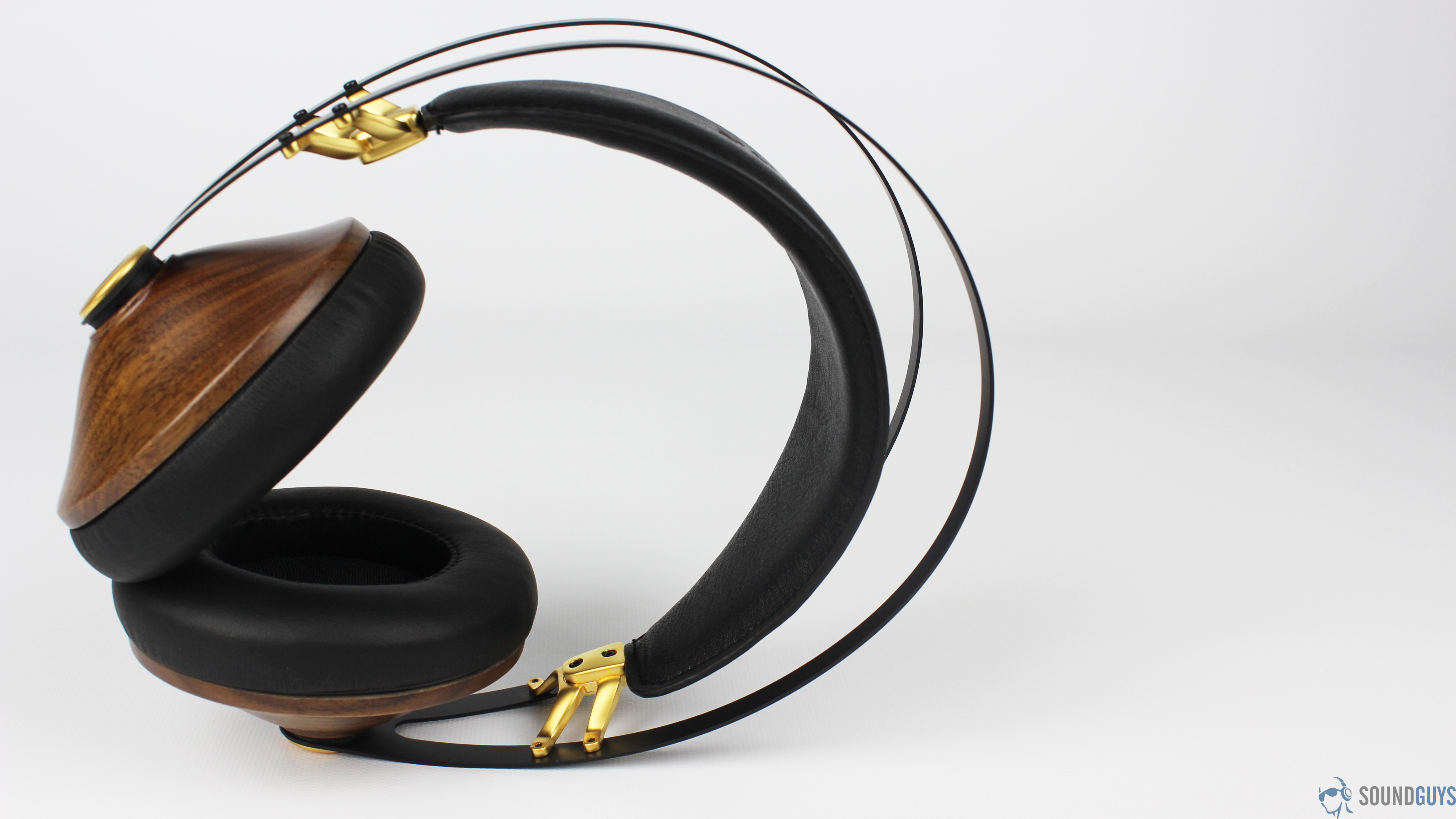 A profile view of the Meze 99 Classics over-ear headphones in walnut/gold.