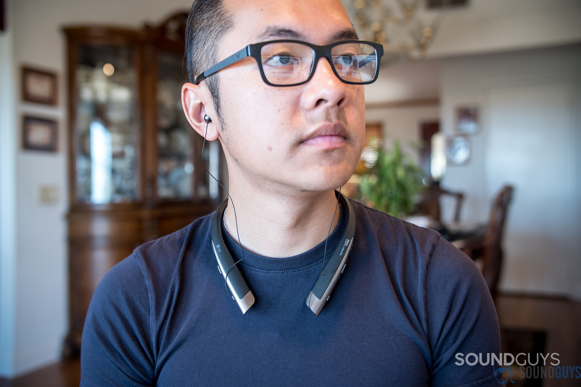 A person wears LG Tone Platinum neckband earbuds.