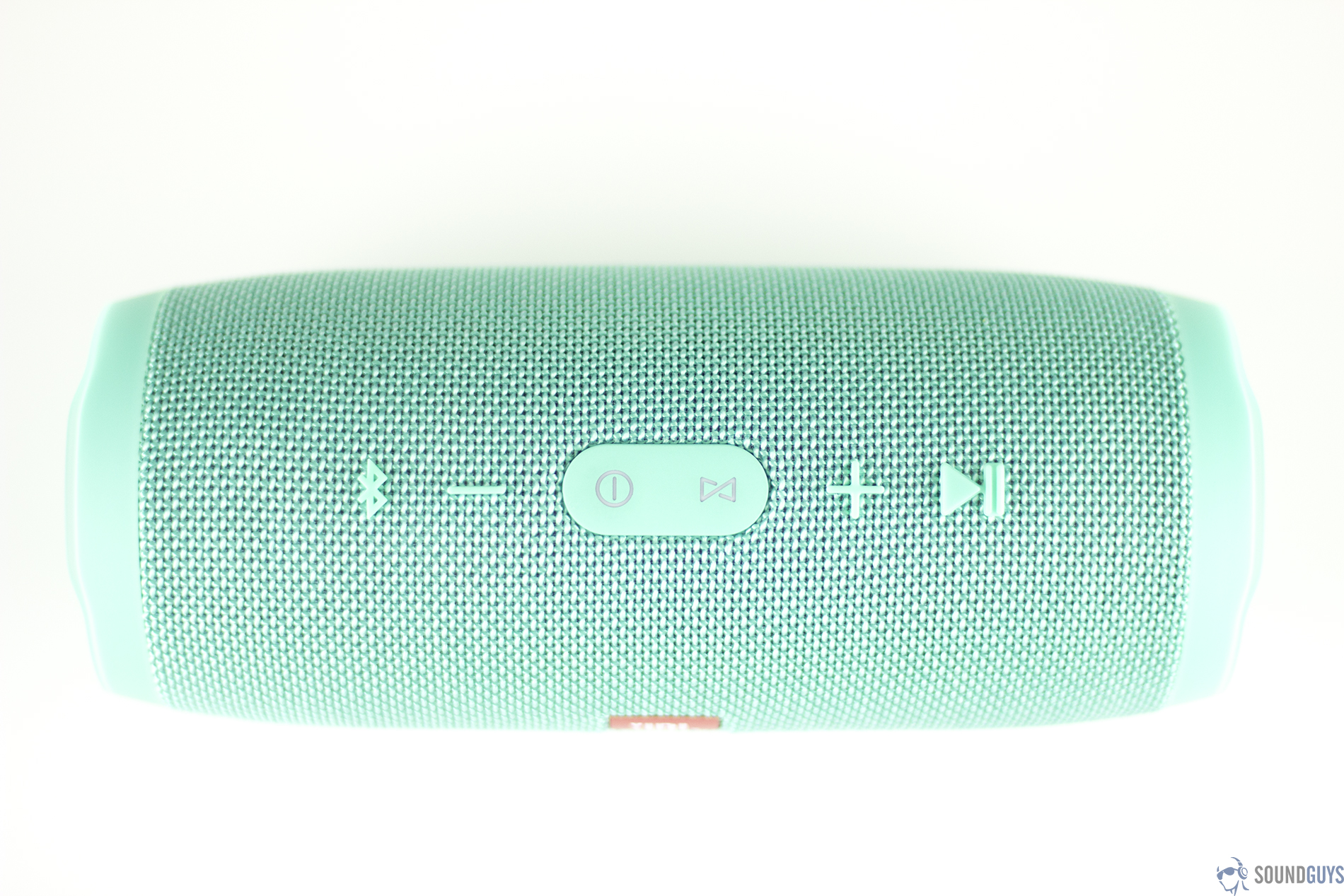 The playback buttons of the teal version of the JBL Charge 3. 