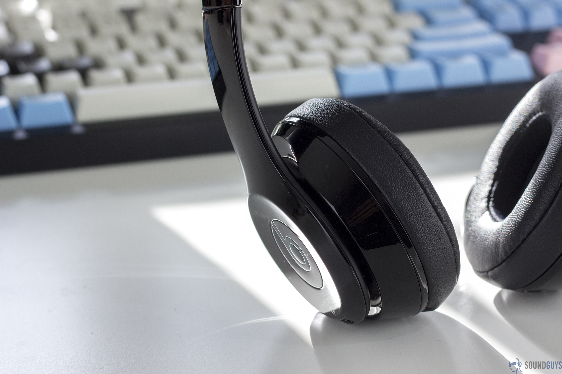 Best headphones under $200: A picture of the Beats Solo 3 in front of a mechanical keyboard.