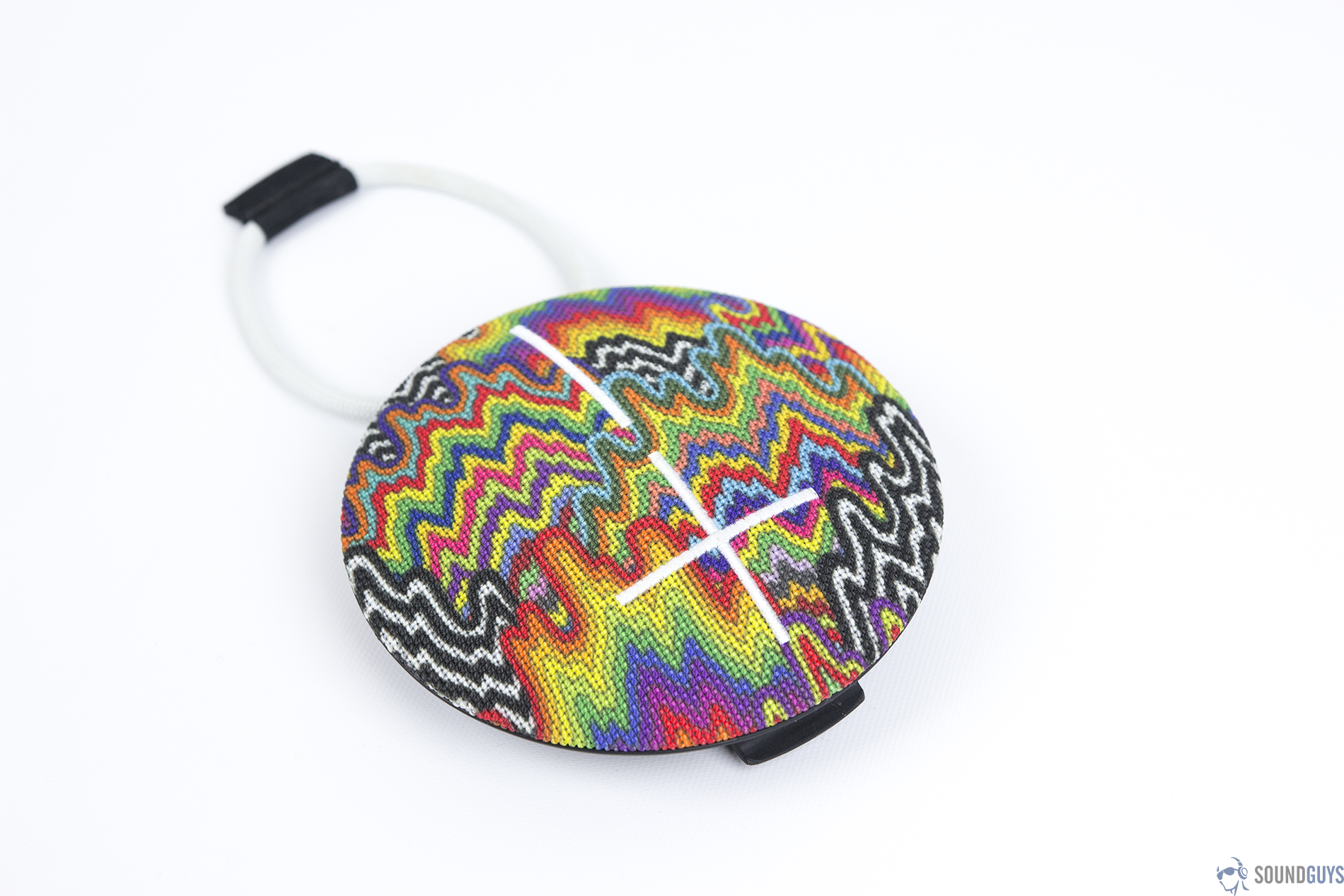 An angled, overhead view of a rainbow-patterned UE Roll 2 on a white background.