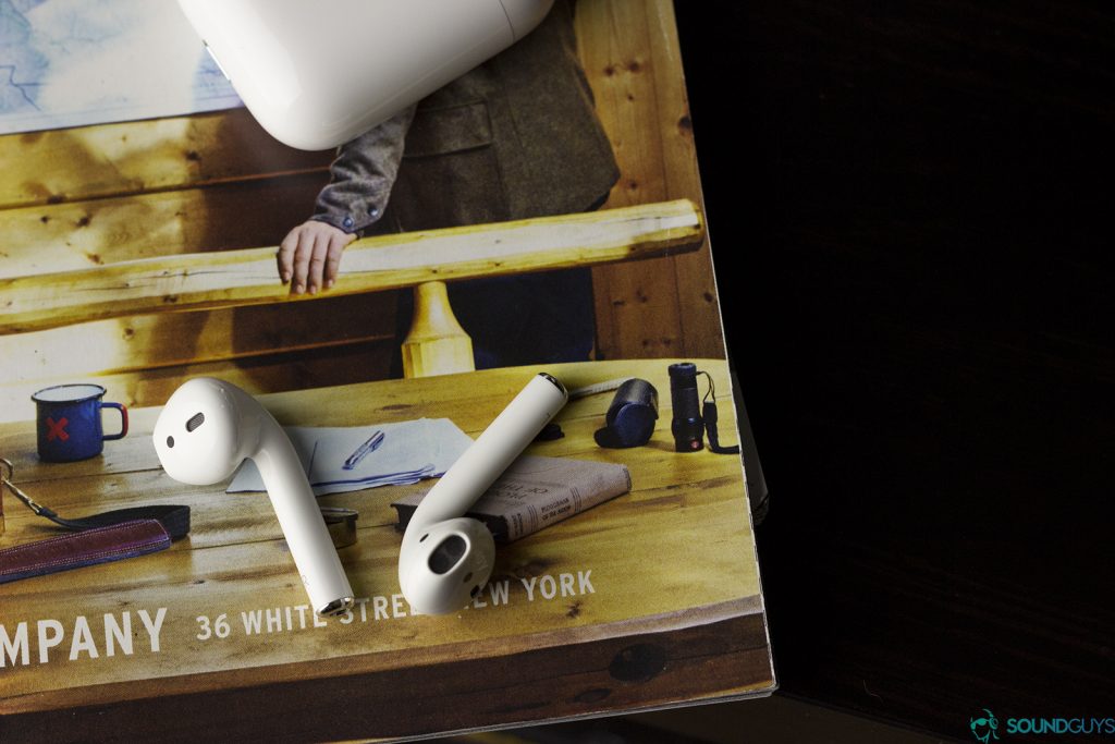 The Apple Airpods are easy to connect, if they're connecting to an iOS device. Android-users will have a more fraught time. Pictured: Apple Earpods laid on a magazine page with the small carrying case at the top portion of the image.