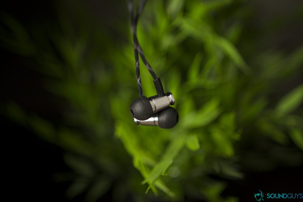 The Forza Metallo earbuds pictured against plants.