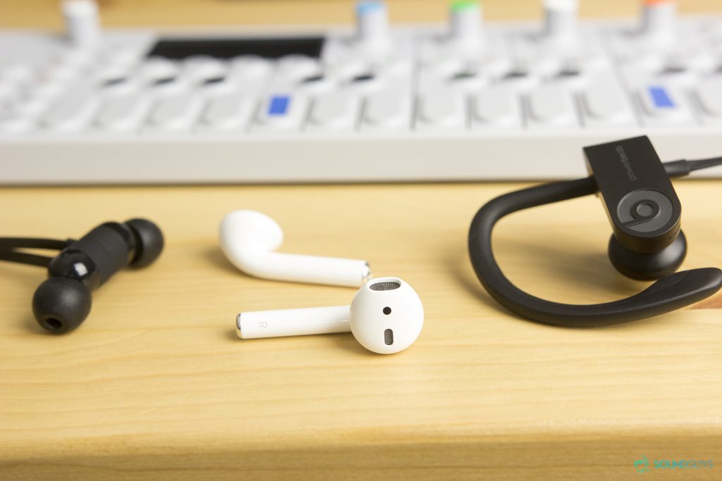 The BeatsX, Airpods, and Powerbeats3 side by side all on a table.