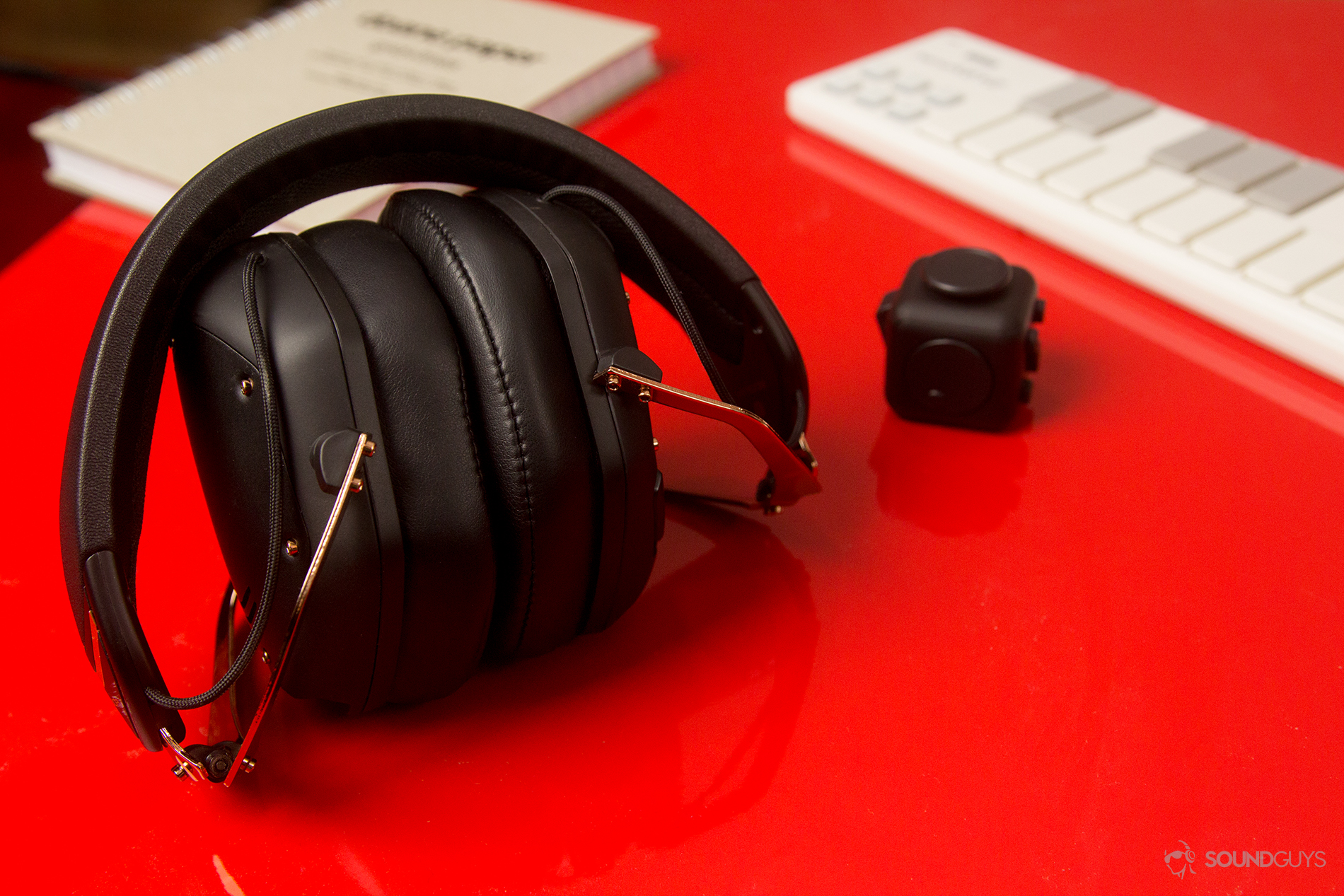 The headphones folded up on a red table.