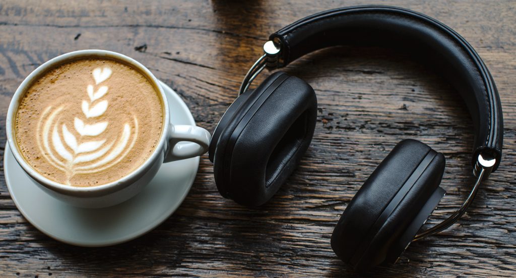 A photo of the Bowers & Wilkins P7 Wireless on a counter next to a coffee.