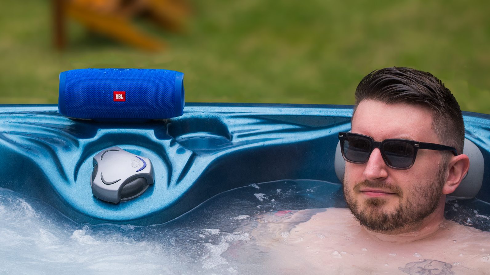 A photo of the JBL Charge 3 in use near a hot tub.