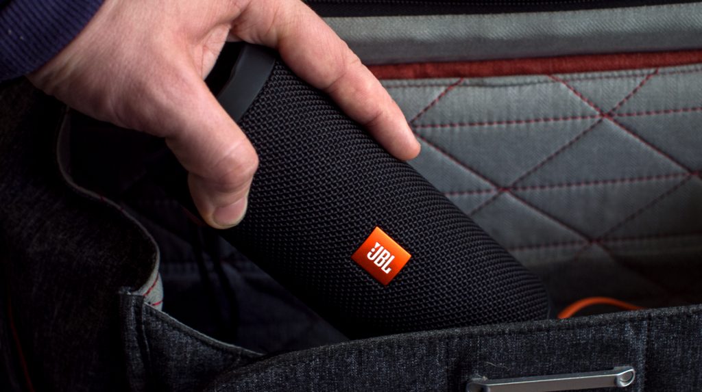 A man inserts the JBL Flip 3 put into a bag.