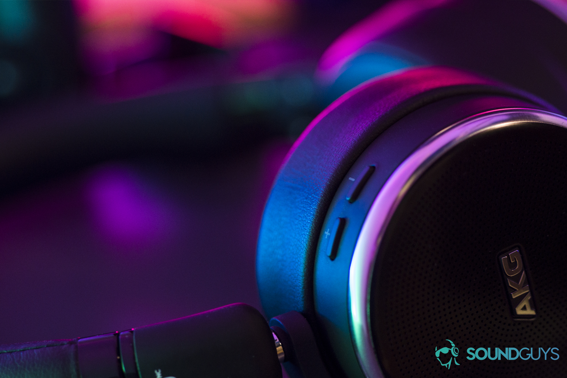 The AKG N60NC in colored light with close-up on the volume buttons.
