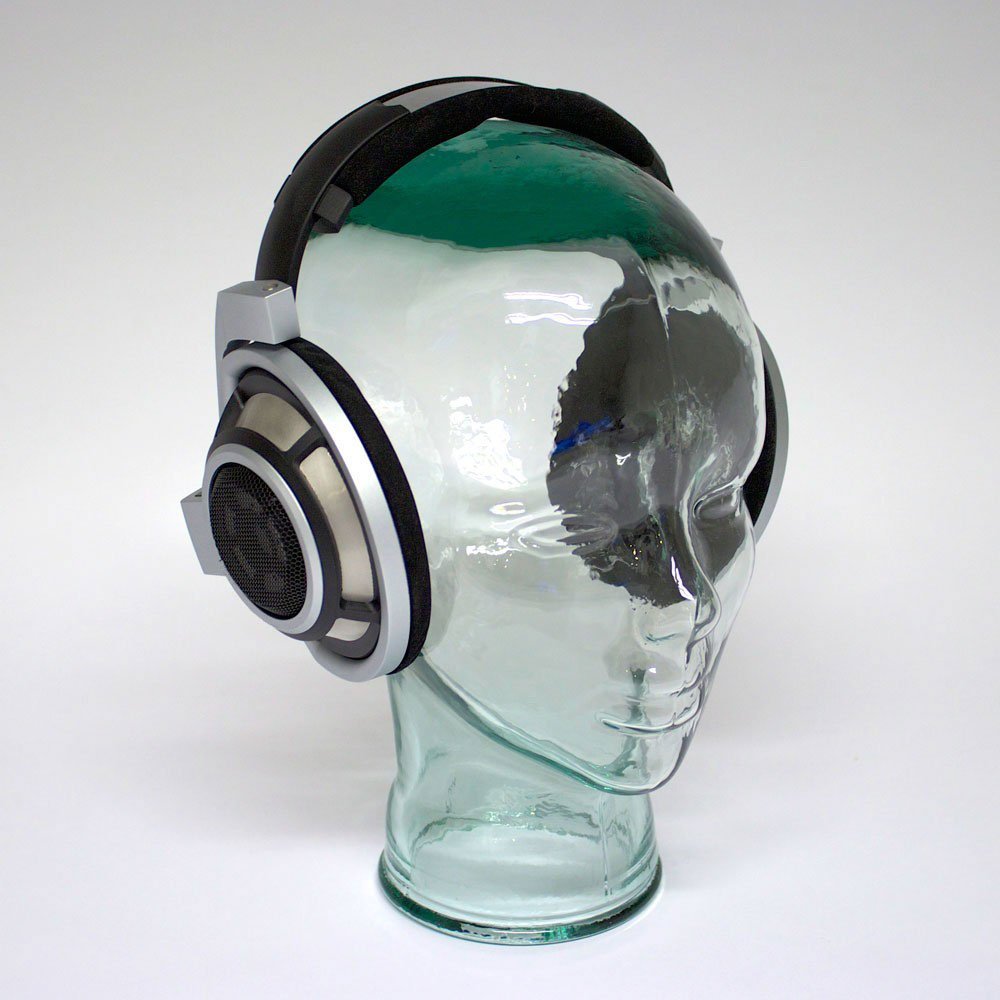 A photo of a glass head wearing Sennheiser HD800 headphones.