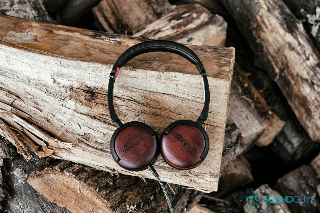 A photo of the Thinksound On2 on a pile of wood.