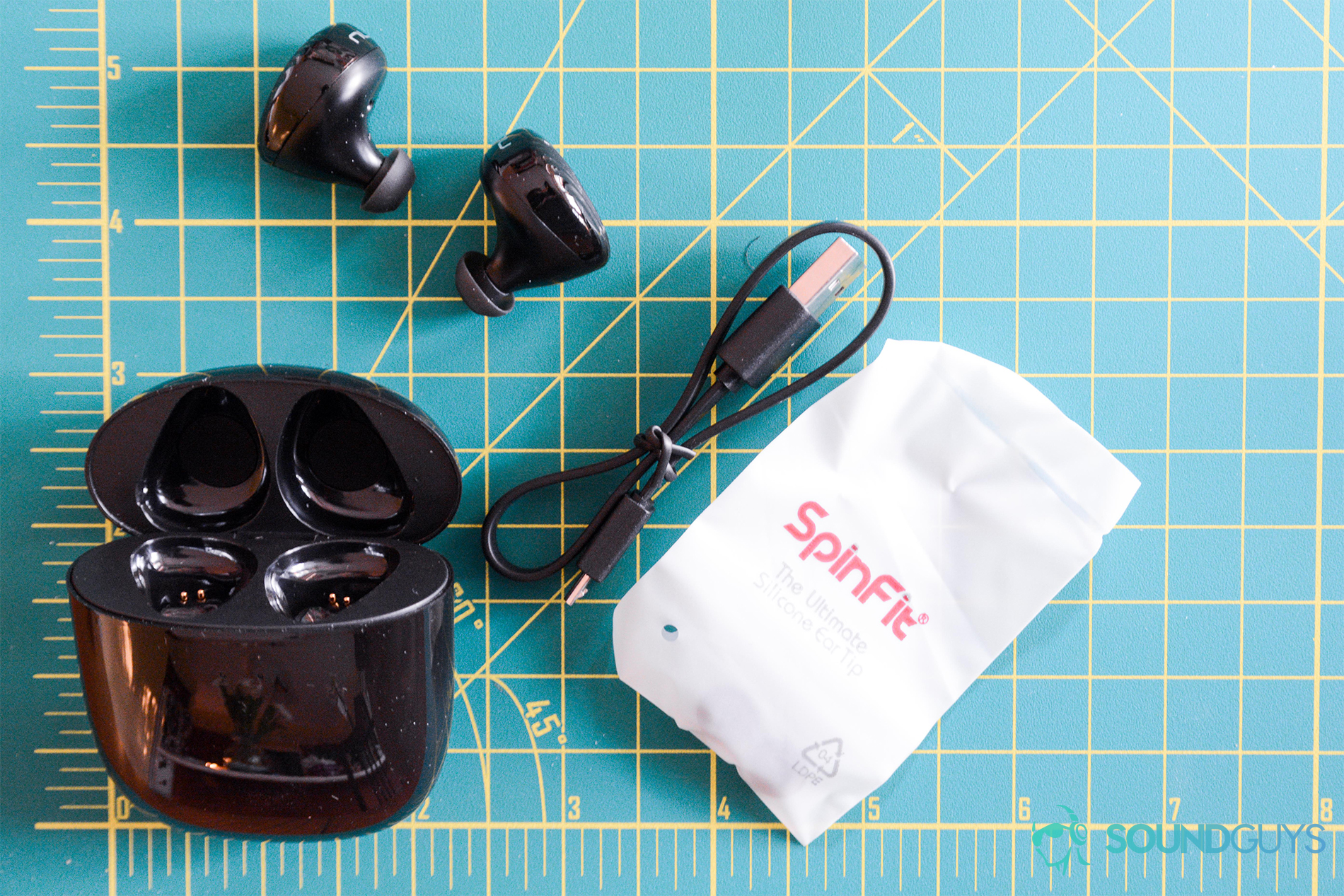 A photo showing every accessory the Optoma NuForce BE Free8 wireless earbuds come with, including the sleeves, charging case, USB cable, and earbuds.