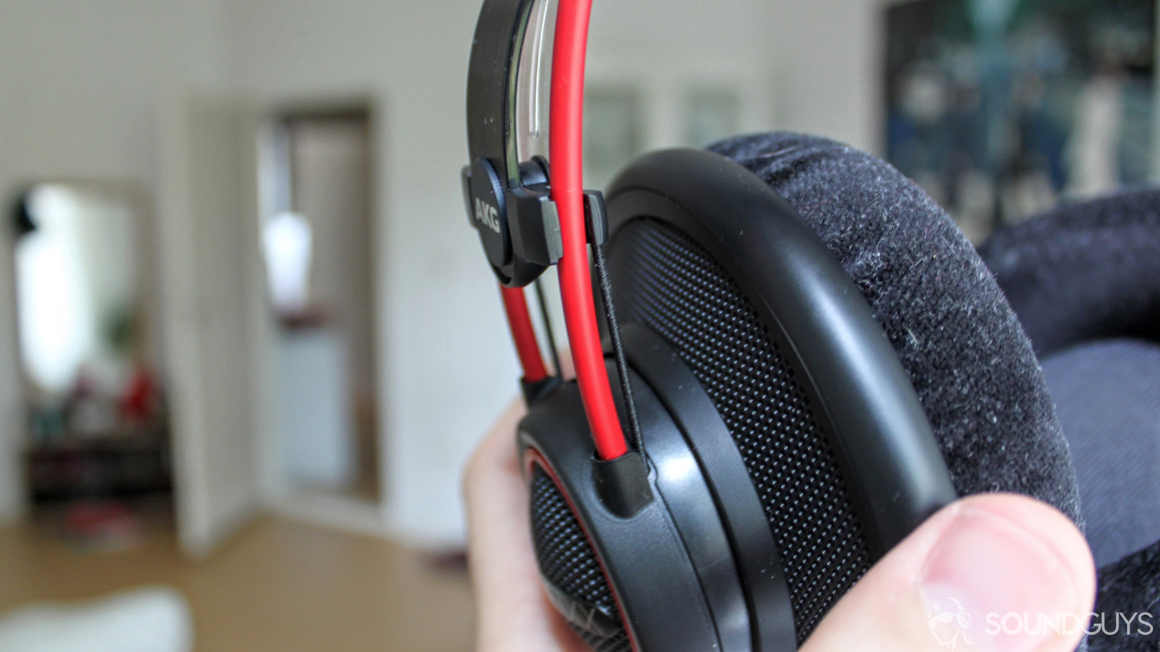 A close-up photo of the AKG K7XX's band joint with the velour earpads also in focus. 