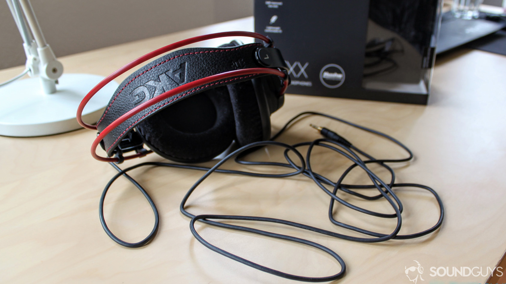 soundguys-akg-k7xx-review-1-9 A photo of the AKG K7XX on a desk with red accents and cable visible.