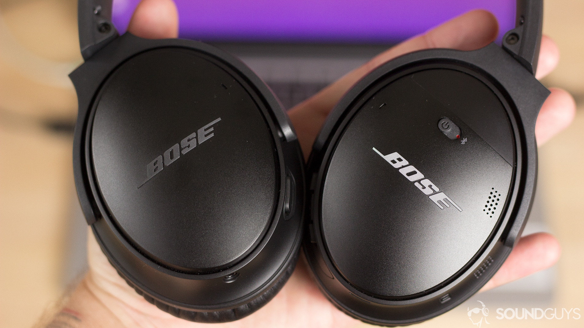 The Bose QuietComfort 35 II headphones in a man's hand.