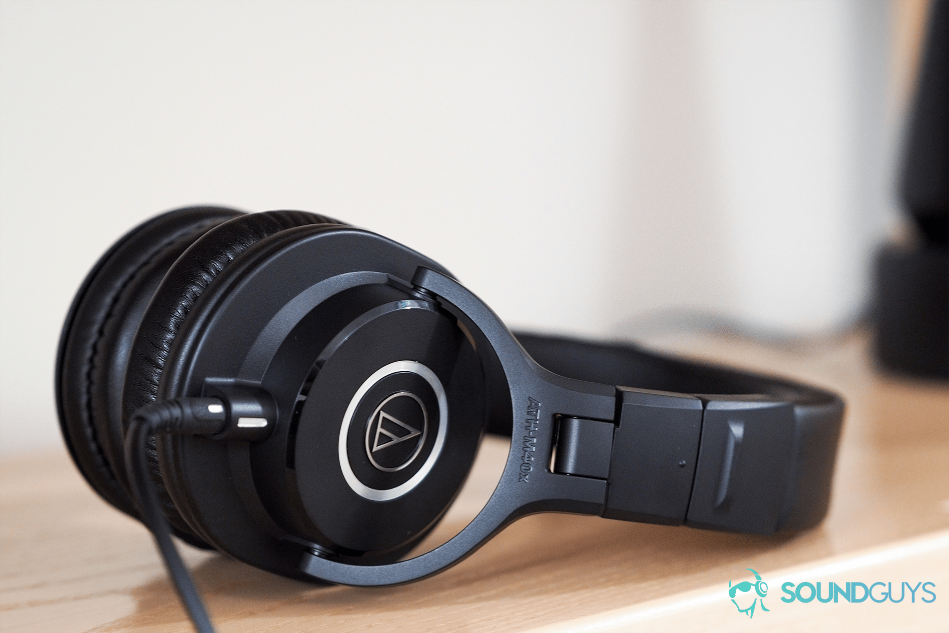 The Audio-Technica ATH-M40x on a wooden shelf.