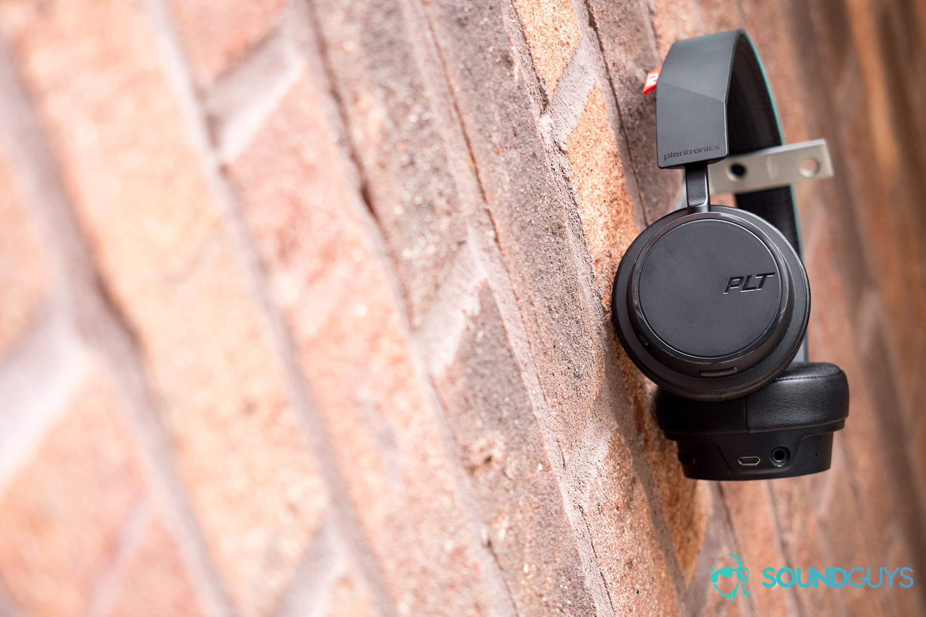 A picture of the Plantronics BackBeat 500 FIT look identical to the BackBeat 500 but feature a P2i water-repellent nano-coating. Pictured: The Plantronics BackBeat 500 FIT hanging on a brick wall.