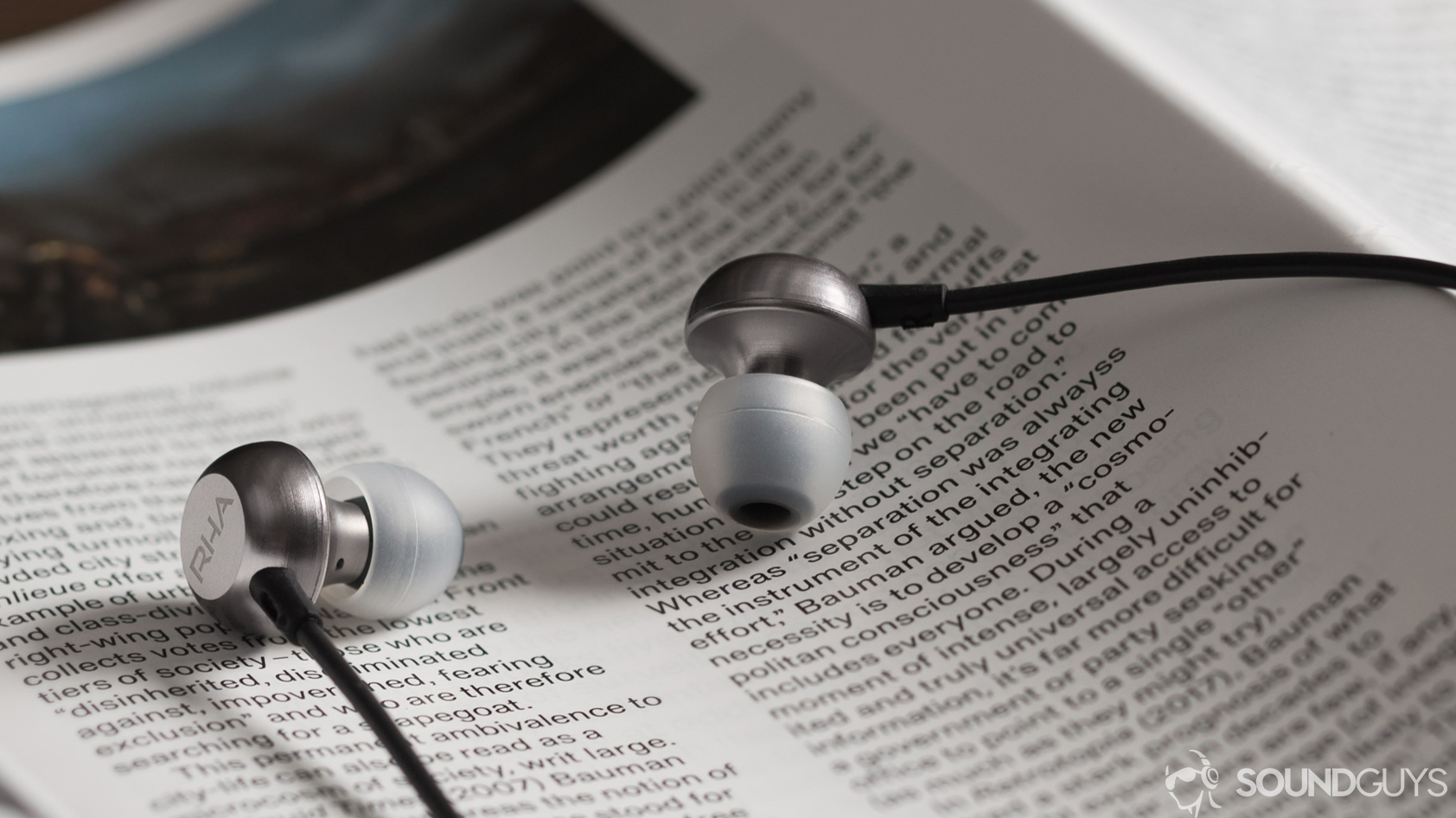 A photo of the RHA MA650 earbuds for Android on a book.