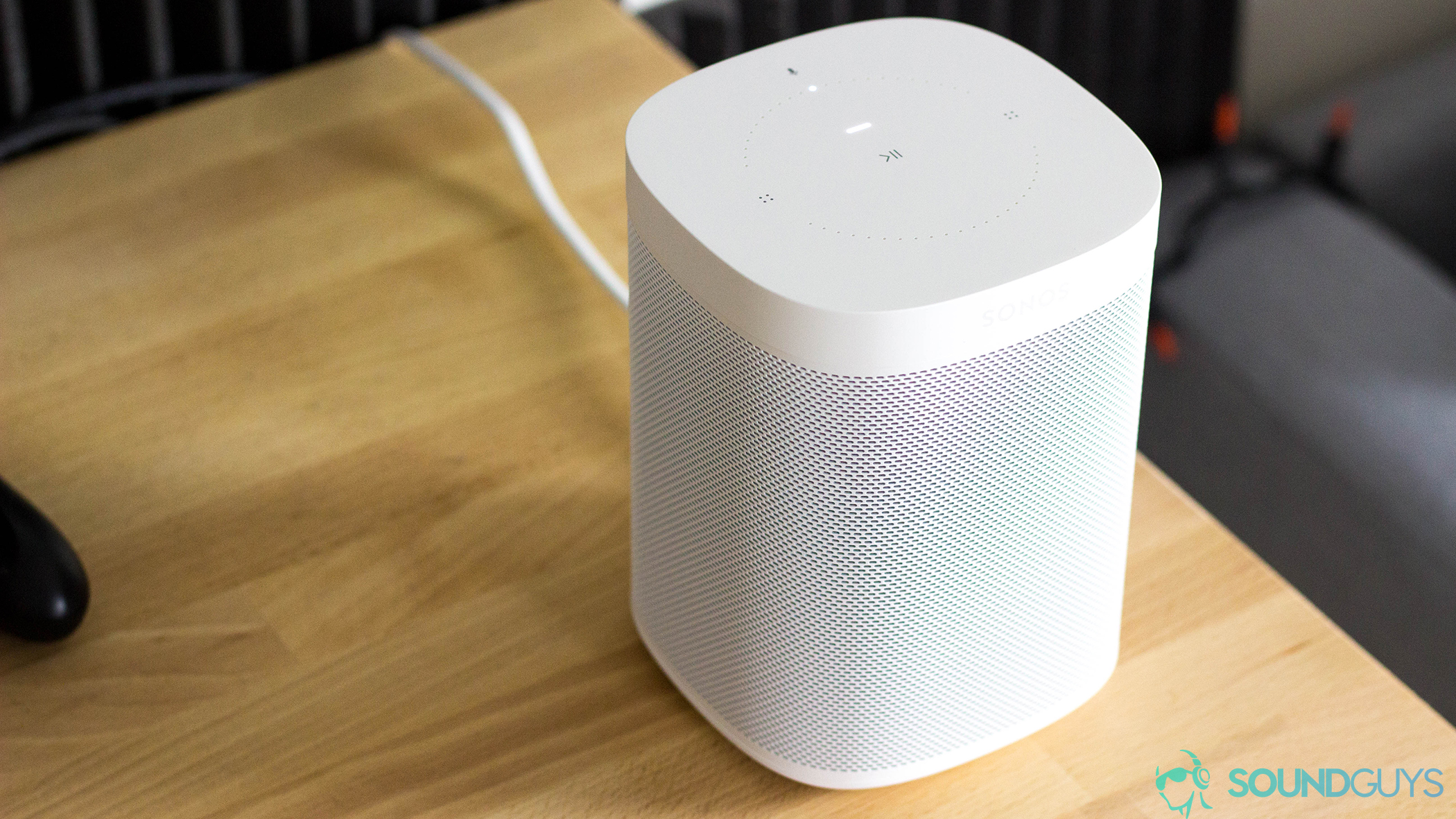 Image of the Sonos One (Gen 1) on a wooden table.