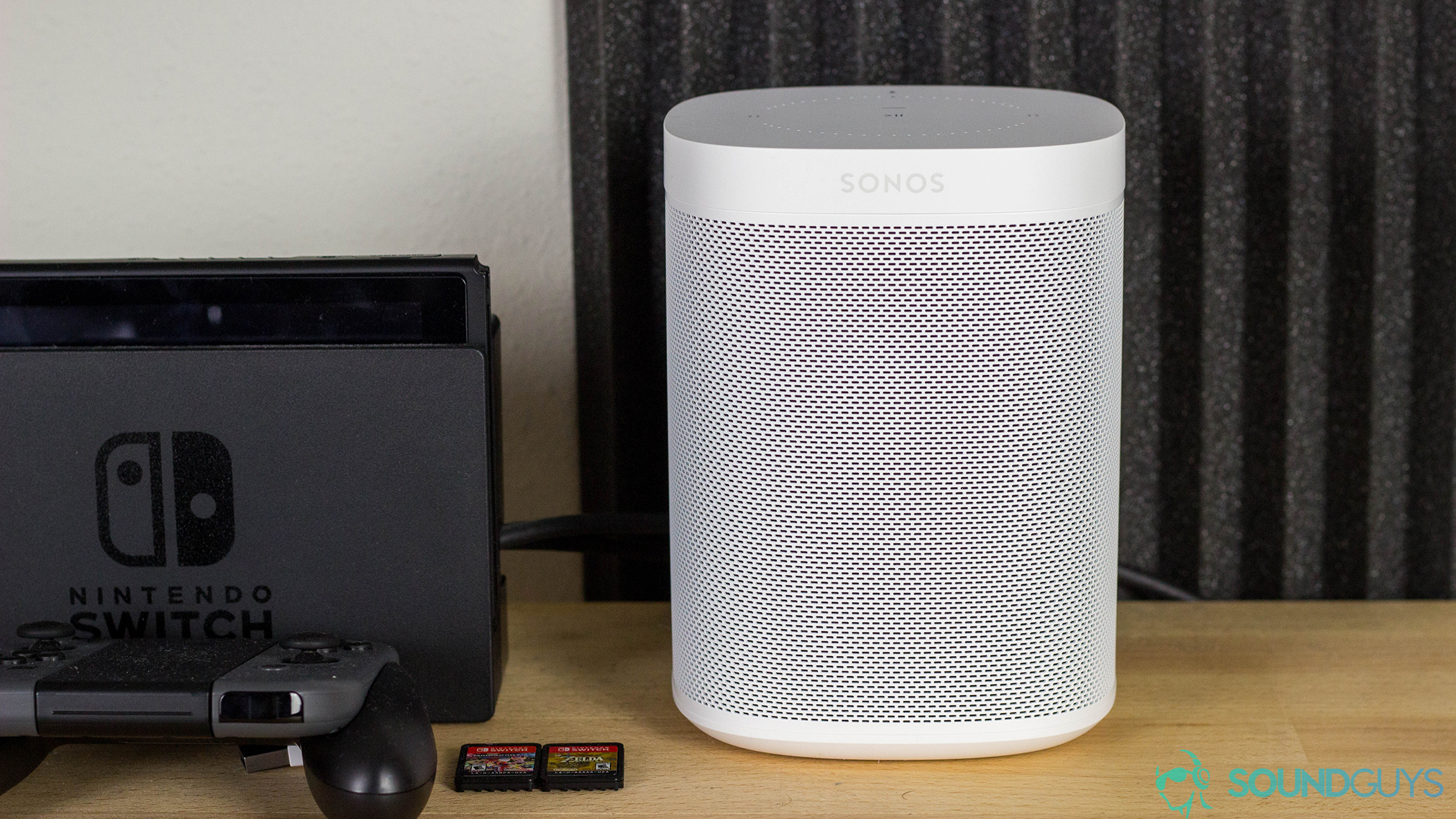 Solis SO-7000 review: The Sonos One on a wooden desk next to a Nintendo Switch.