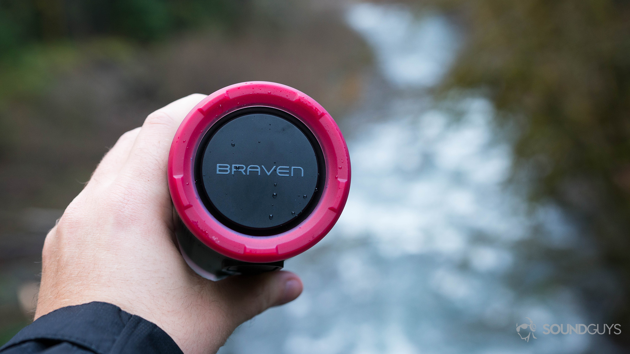waterproof speakers Braven Stryde in the hand in front of a waterfall