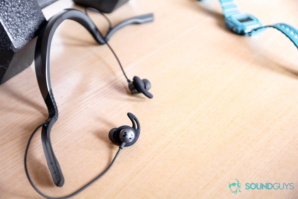 Under Armour Sport Flex Wireless by JBL earbuds with the neckband flexing out into an "ohm" symbol position.