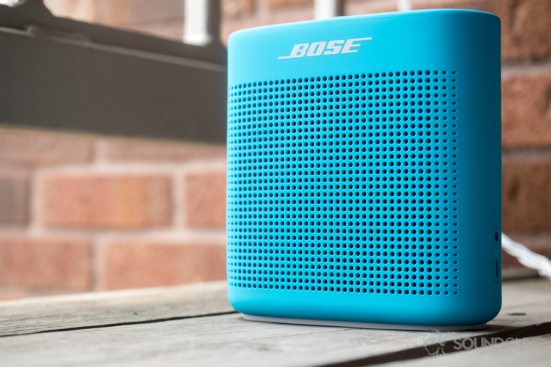 The SoundLink Color II is one of many Bose products that is compatible with the Bose Connect app, which lets users control volume, update firmware, and switch between devices. Pictured: The Bose SoundLink Color II speaker at an angle on a balcony.