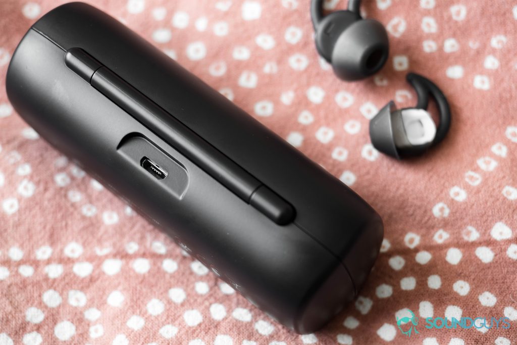 A photo of the Bose SoundSport Free true wireless workout earbuds charging case's microUSB input with StayHear+ ear tips in the top-right corner of the image.