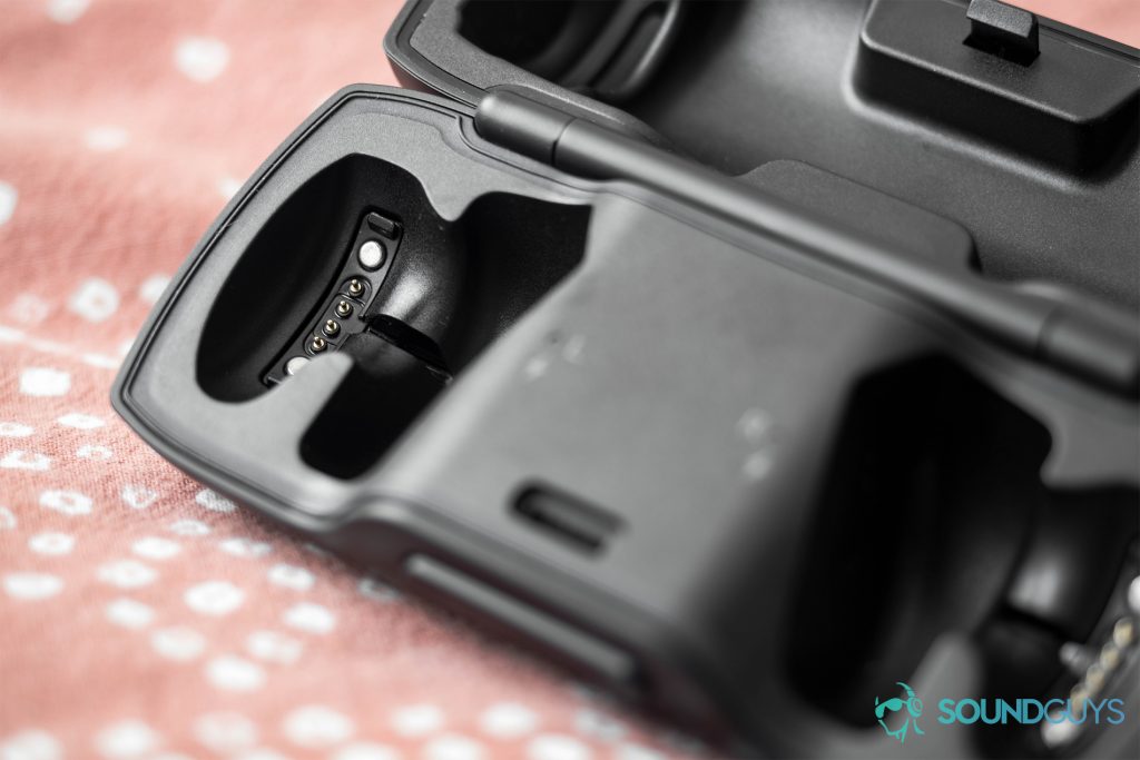The Bose SoundSport Free charging case is open without the earbuds inserted to detail the magnetized connectors.