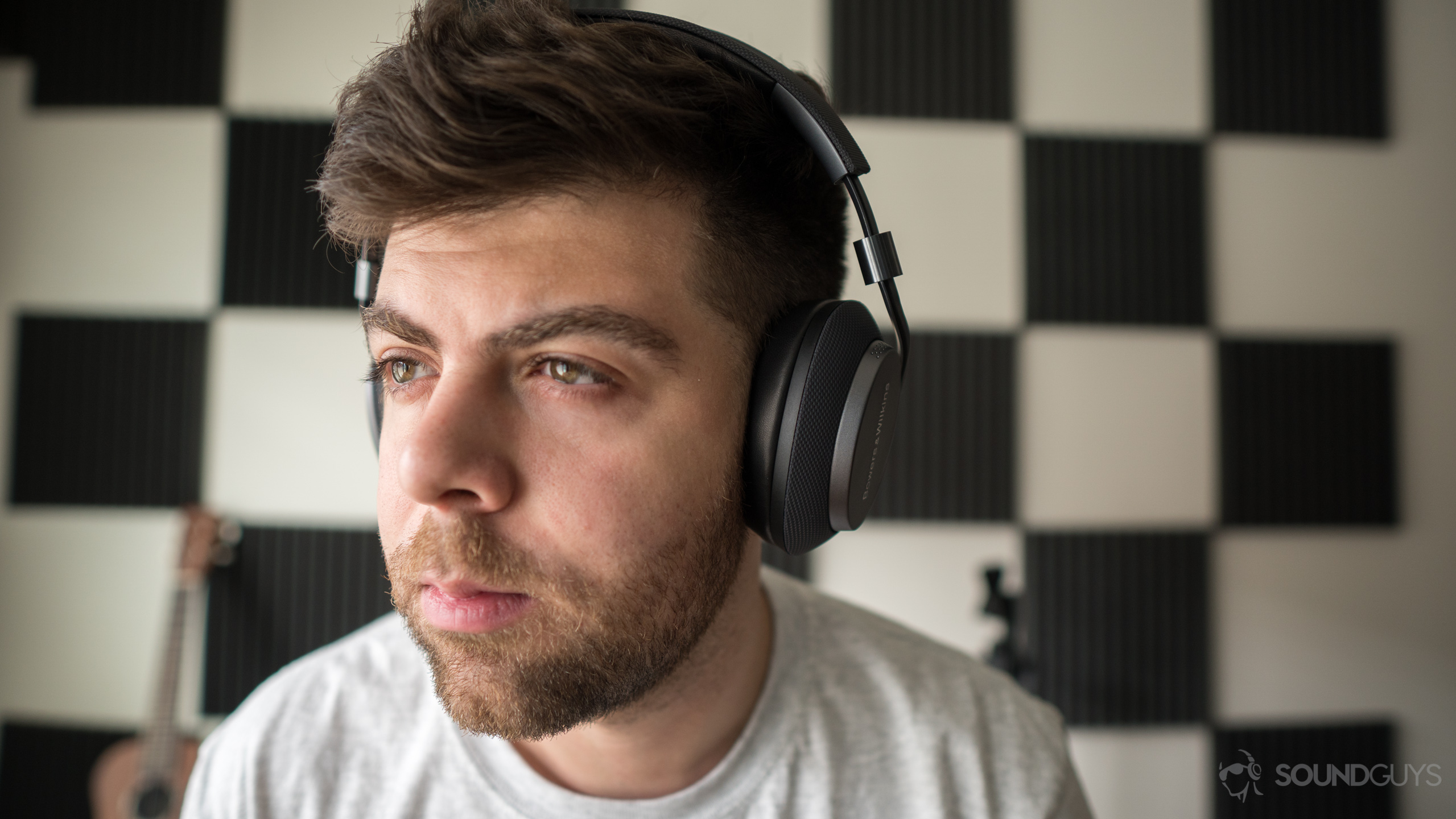 Bowers & Wilkins PX-9 A photo of a man hearing wireless Bluetooth headphones, the Bowers & Wilkins PX.