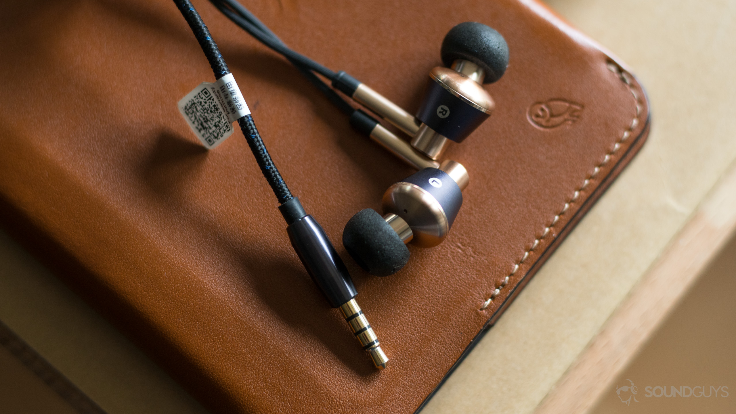 The 1MORE Triple-Driver in-ears on a desk