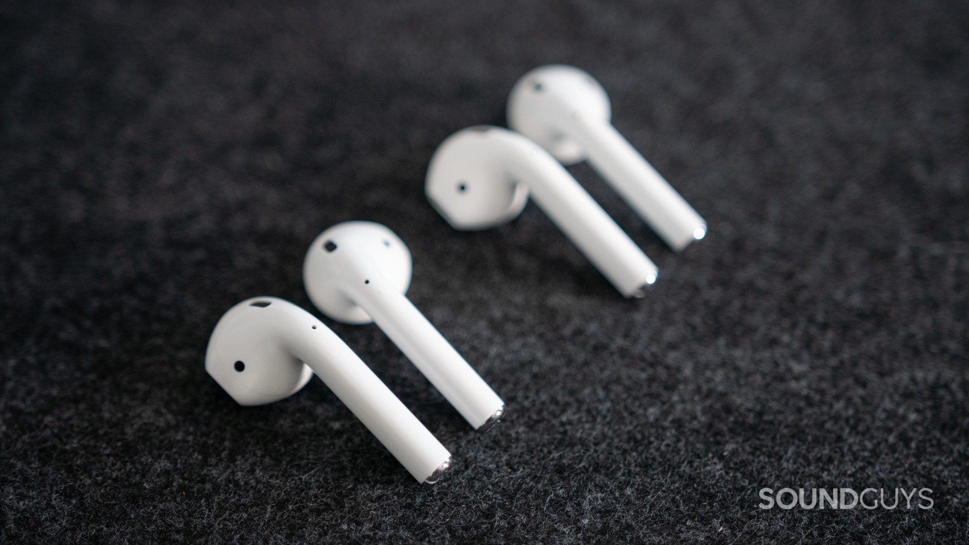 The old and new Apple AirPods (2019) next to each other.