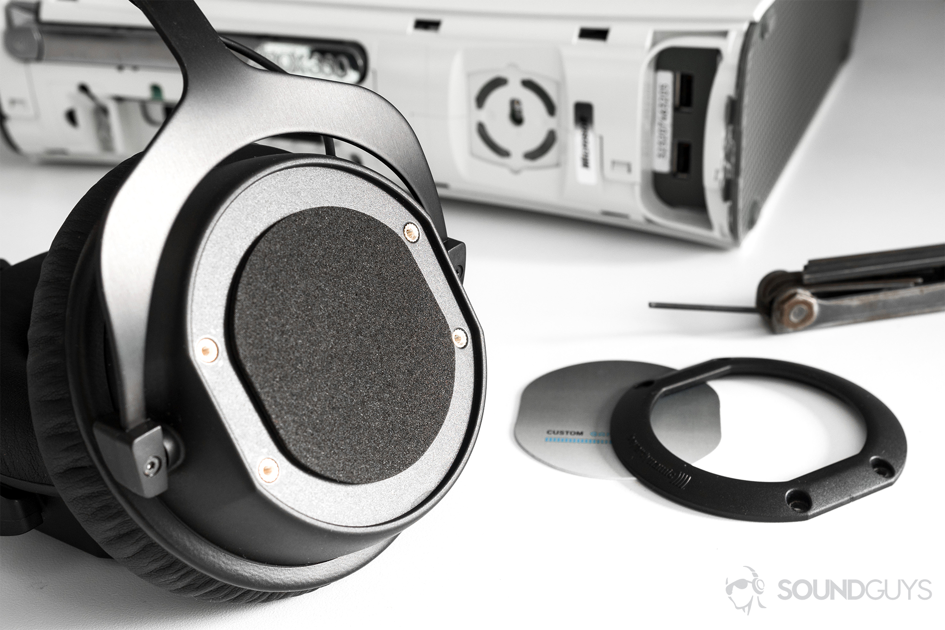 Beyerdynamic CUSTOM Game: The headphones are angled off to the side, unsheathed to replace the ear cup plates.