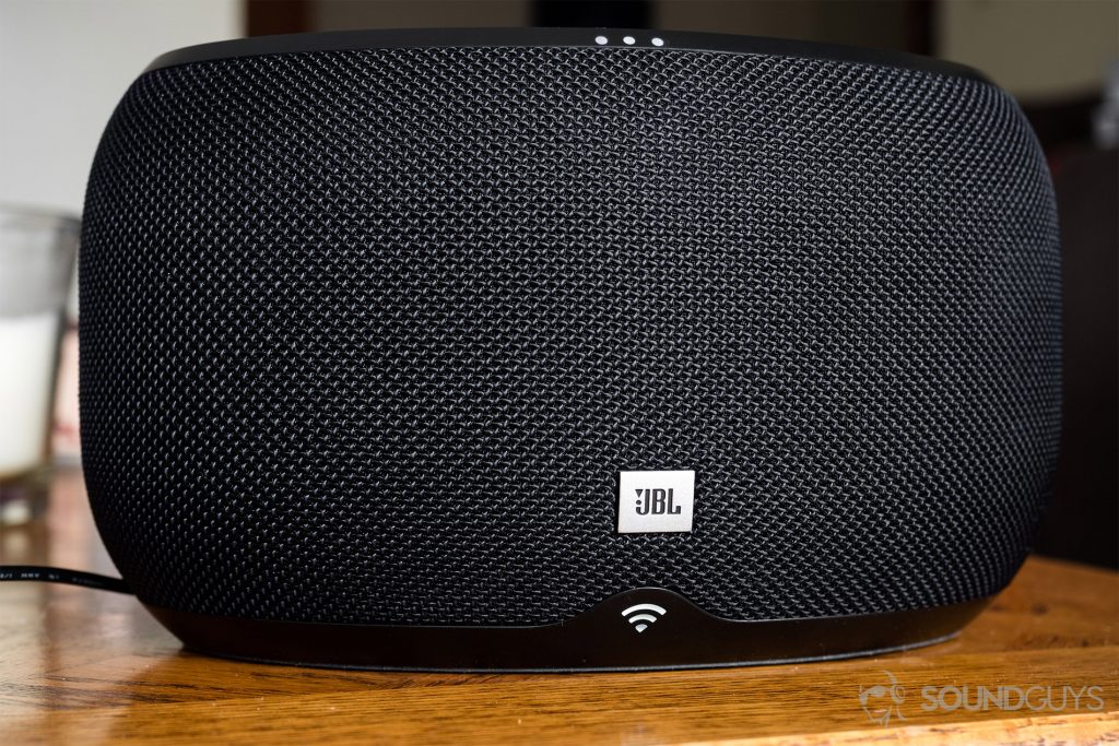 JBL Link 300 Google Assistant-integrated smart speaker: A straight-on shot of the speaker in black. The top three (of four) LEDs are lit up as well as the bottom WiFi LED.