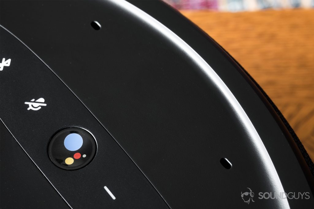 JBL Link 300 Google Assistant-integrated smart speaker: A top-down view of the speaker at a close-up. The Google Assistant button and dual mics are featured.