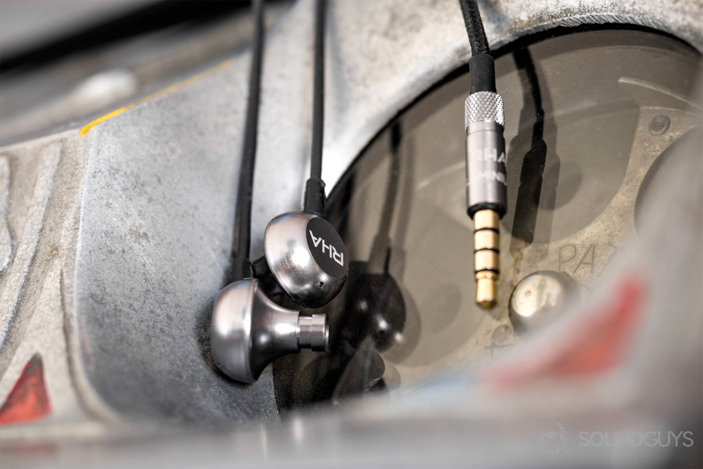 The RHA MA650 earbuds mimic the same aerophonic design as the MA750; this reduces distorting reverberations within the audio chamber. Pictured: The RHA MA650 earbuds in front of the revolving coin insert of a vintage PACE slot machine.