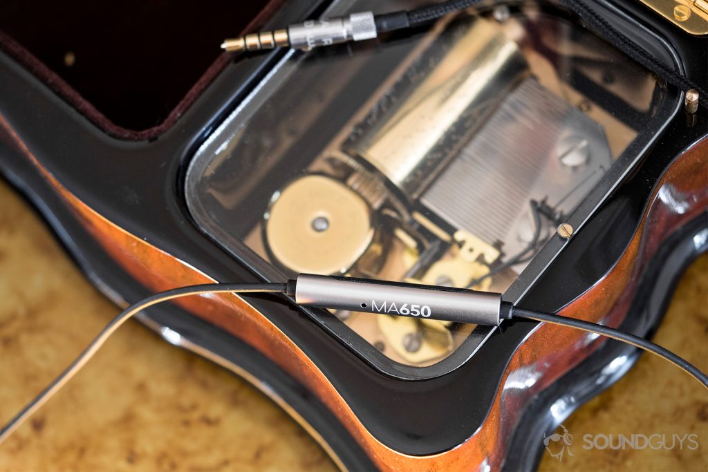 Best earbuds under $20: Located on the back of the in-line remote, the RHA MA650 microphone effectively picks up the speaker's voice during calls. Pictured: The RHA MA650 microphone and 3.5mm headphone jack on top fo an open music box.