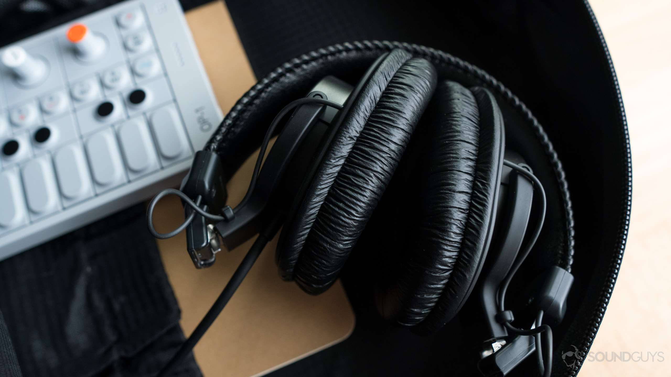 The MDR-7506 headphones folded up in a backpack.