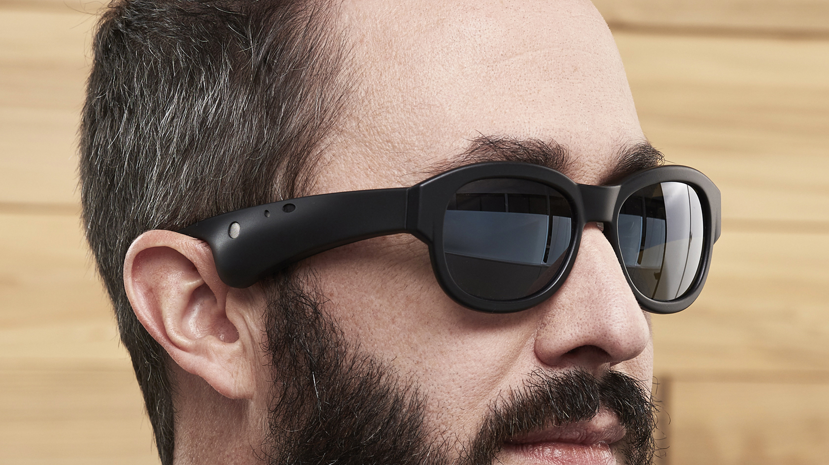 A manufacturer-supplied image of the Bose AR glasses being worn by a bearded man