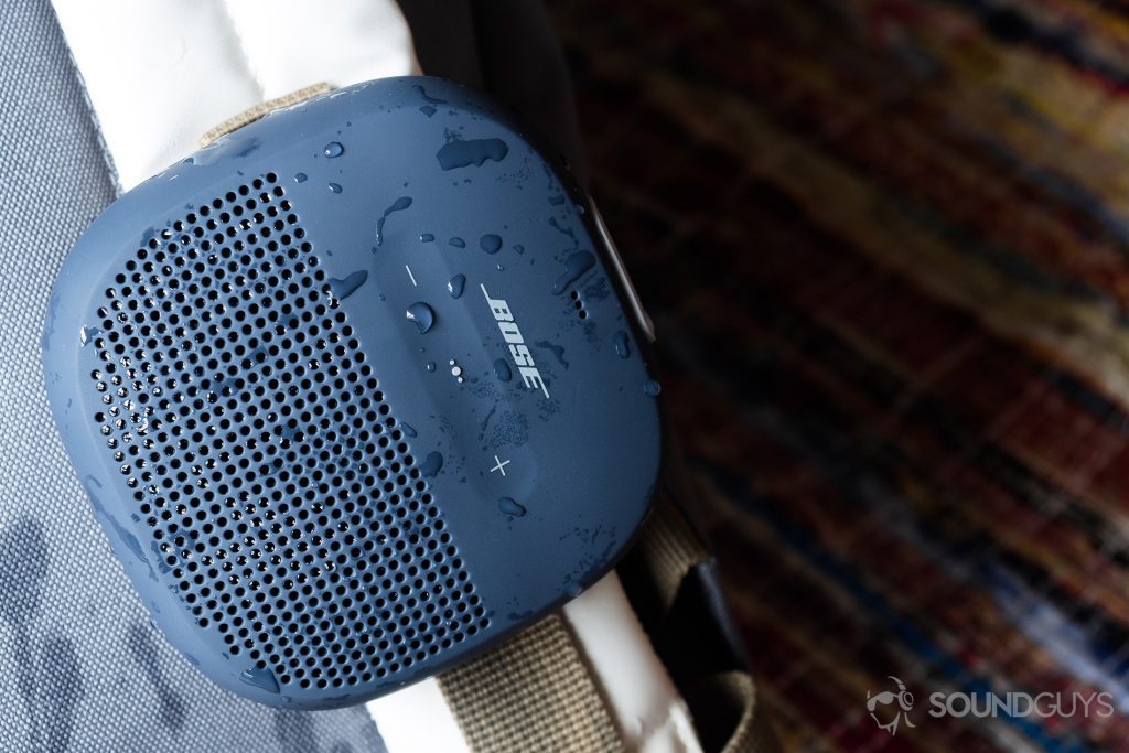 Best Bluetooth speakers under $100: The Bose SoundLink Micro (blue) hooked onto a white backpack.