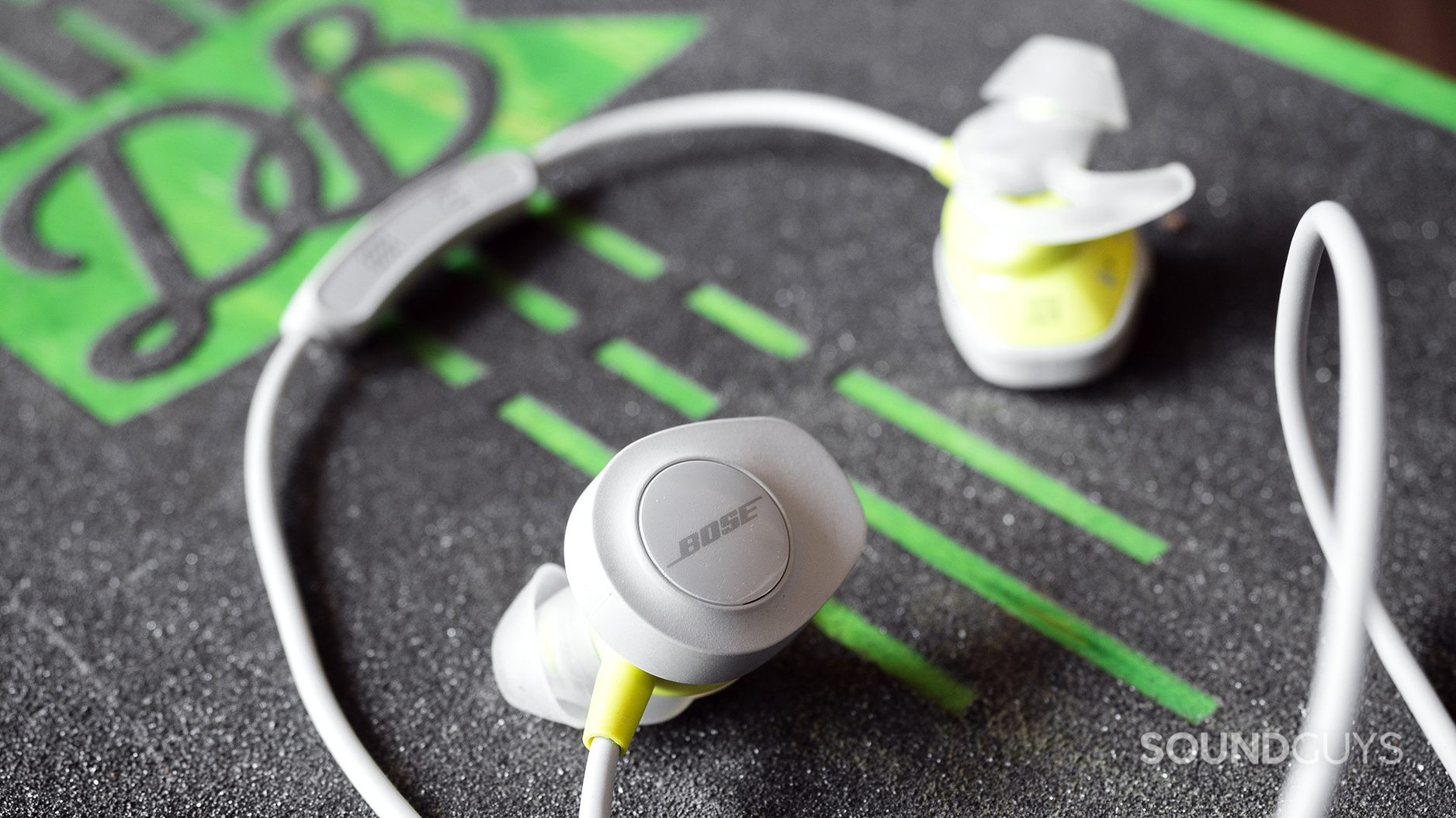 The Bose SoundSport Wireless earbuds on a skateboard.